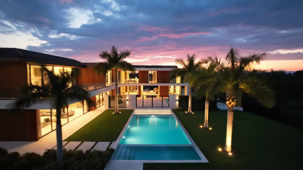 Modern luxury villa with an infinity pool at sunset